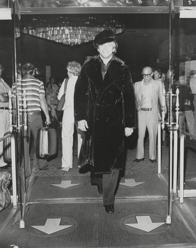 Scott Thorson leaves the Dunes Hotel, still wearing the black llama .jacket and cap he modeled there for Anna Nateece's fashion show. Scott was Liberace's lover (played recently by Matt Damon in 'Behind the Candelabra) and Anna was Liberace's gown and fur designer. Circa 1980. Courtesy Anna Nateece's.